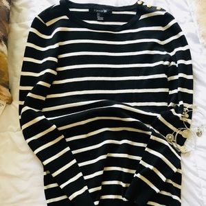 A long sleeve black and white stripped shirt.